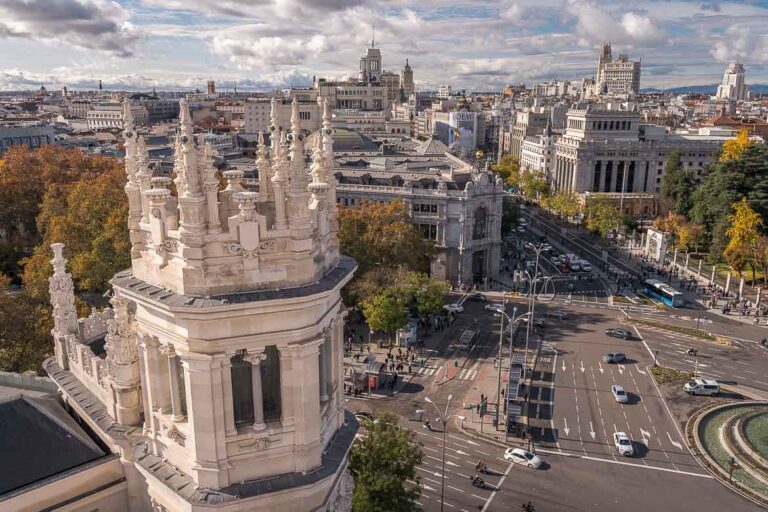 This image shows a panoramic view of Plaza de Cibeles and Gran Via from the Palacio de Cibeles terrace.