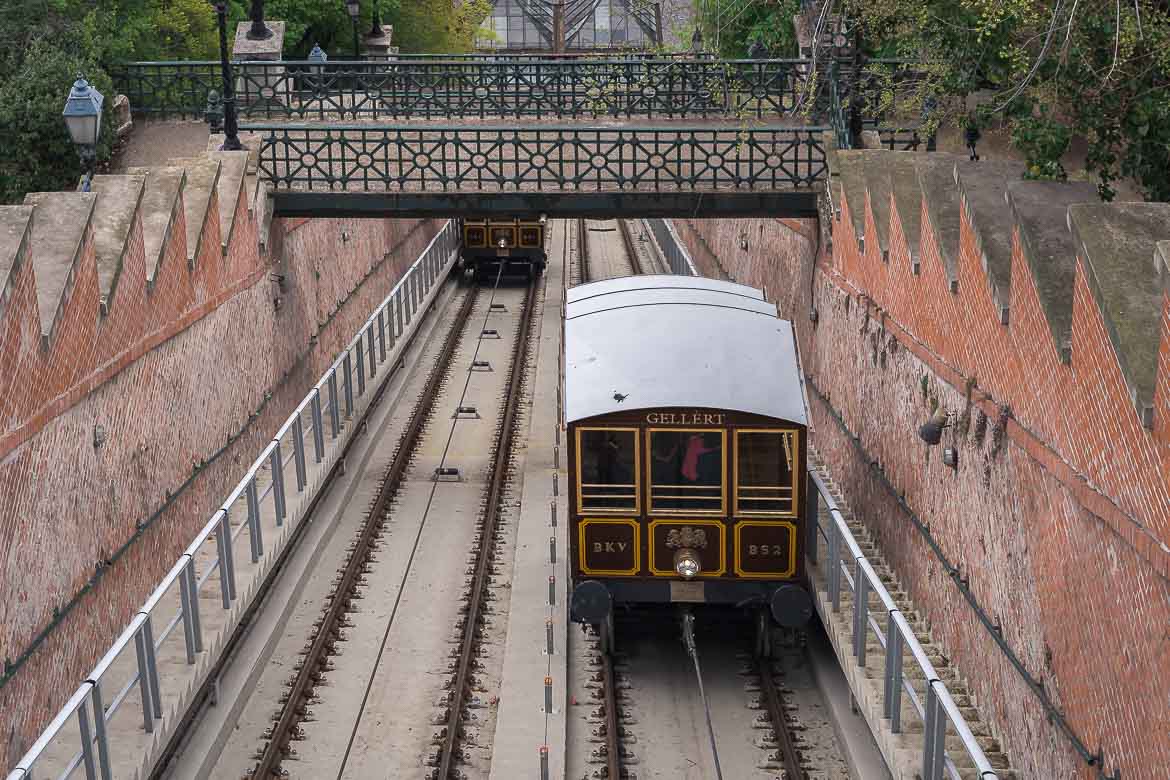 This image shows the Buda Castle Funicular. The wooden carriage on the right ascends while the carriage on the left descends.