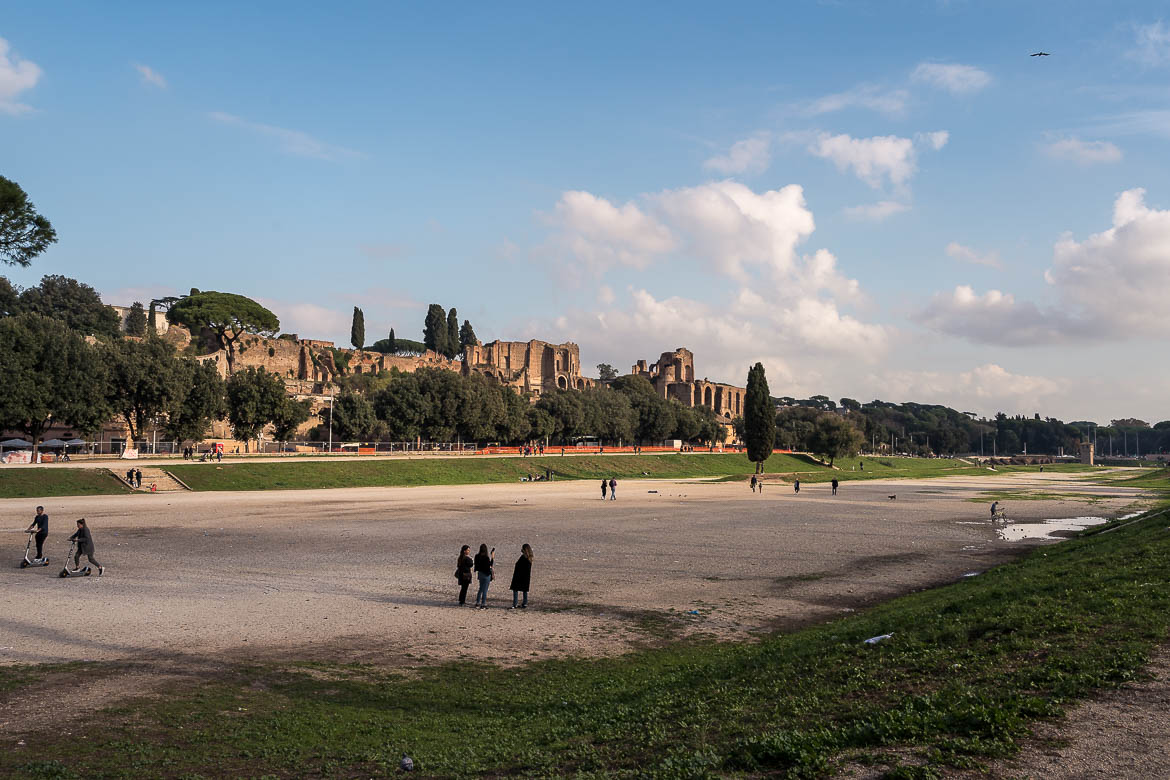 This is a panoramic shot of Circus Maximus. There's nothing in this photo to remind of the ancient stadium. It looks like a lovely park rather than an archaeological site. In the background, the ruins of Palatine Hill are visible.