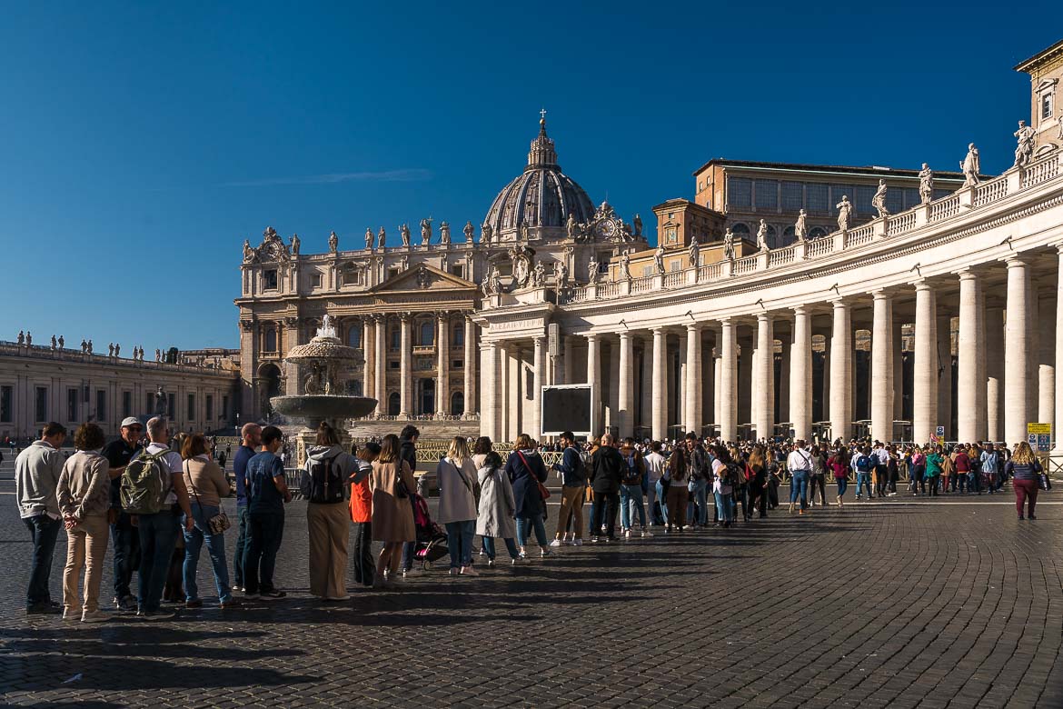 This image shows a super long queue of people waiting to enter St. Peter's Basilica.