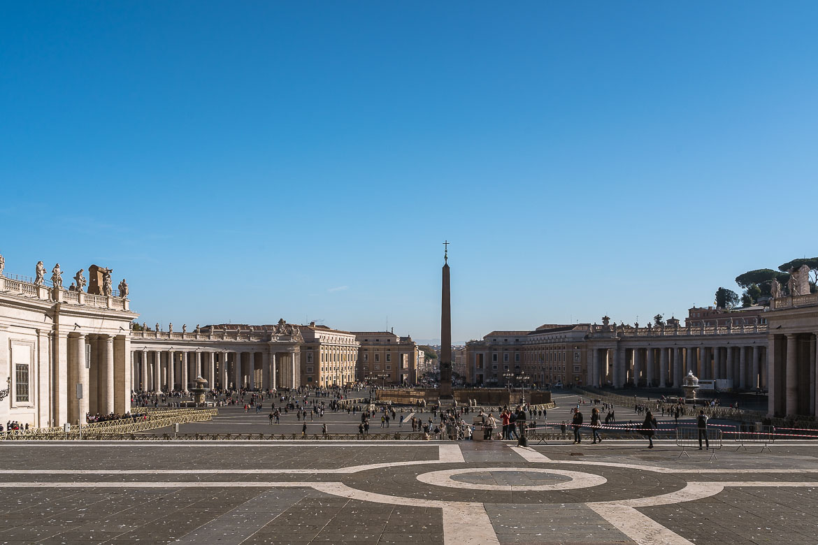 This is a panoramic shot of St. Peter's Square with the obelisk in the middle and the colonnades surrounding it.