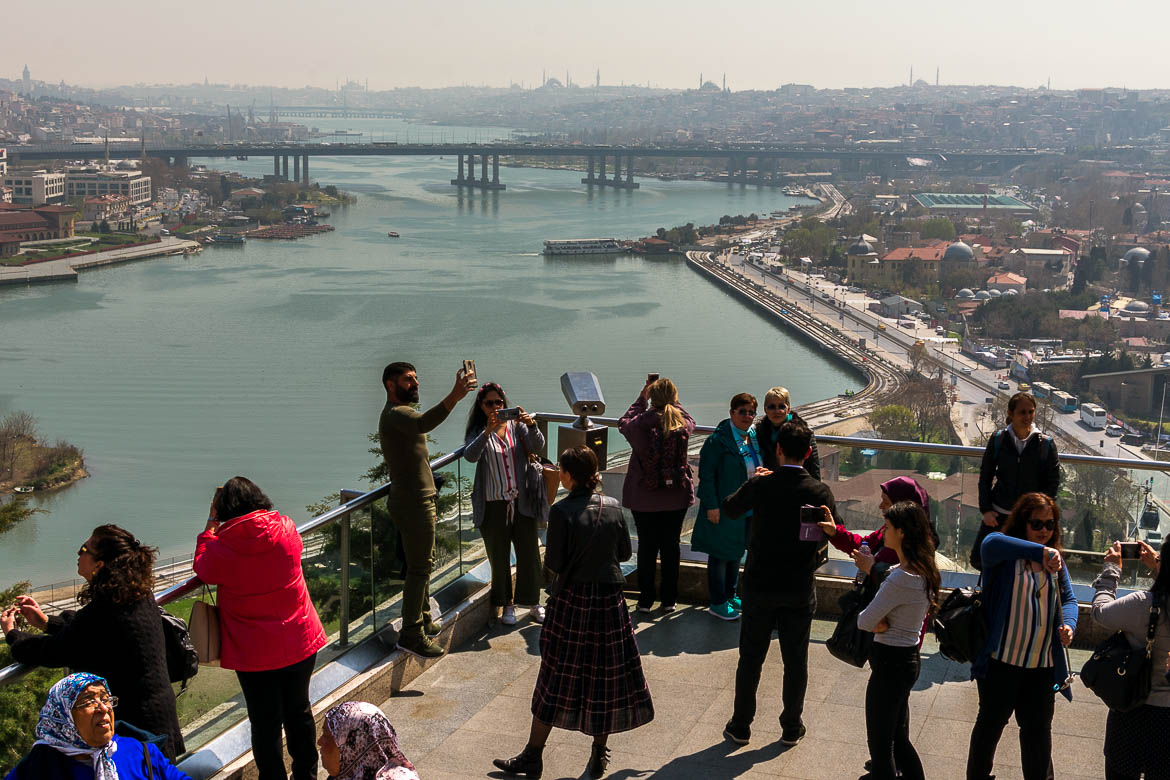 This photo shows people admiring the view to Istanbul city centre from a viewing terrace at Pierre Loti Hill.