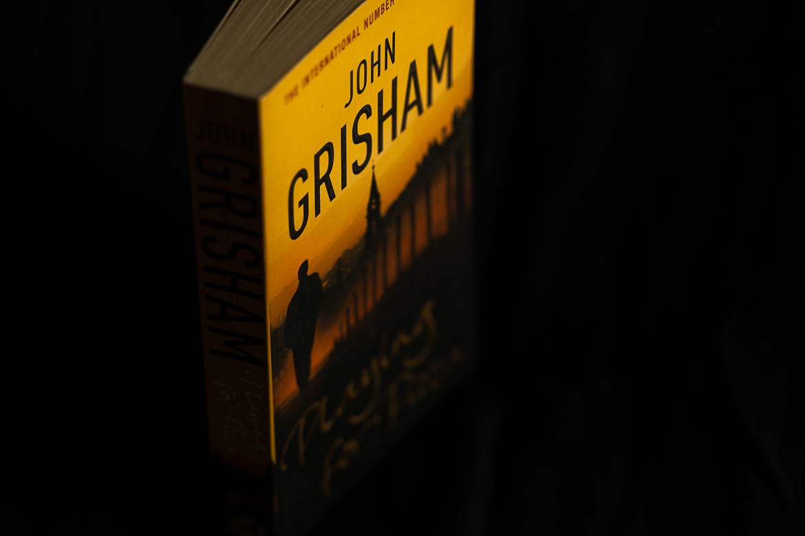 This image shows a paperback edition of Playing for pizza by John Grisham.