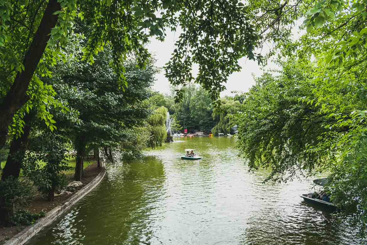 This is a photo of the lake in Cismigiu garden, the oldest park in Bucharest. Renting a rowboat or just walking around its quiet alleys is among the top things to do in Bucharest, Romania.