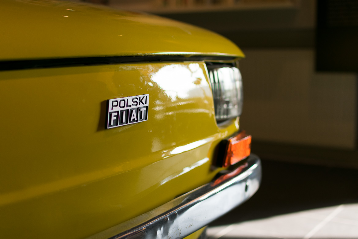 This is a close-up of a yellow vintage FIAT inside the Museum of Life Under Communism, a great place to visit in Warsaw in winter.
