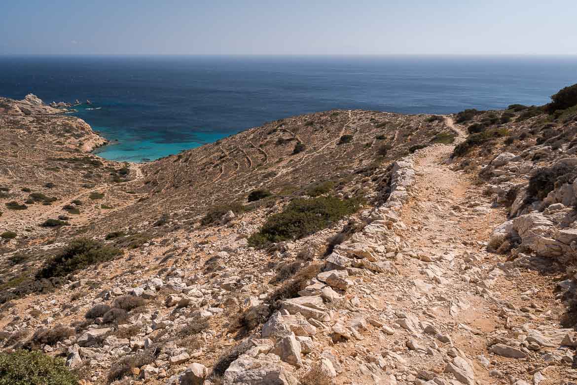 This image shows a shadeless hiking trail on Donoussa Island with gorgeous views of the Aegean Sea. 