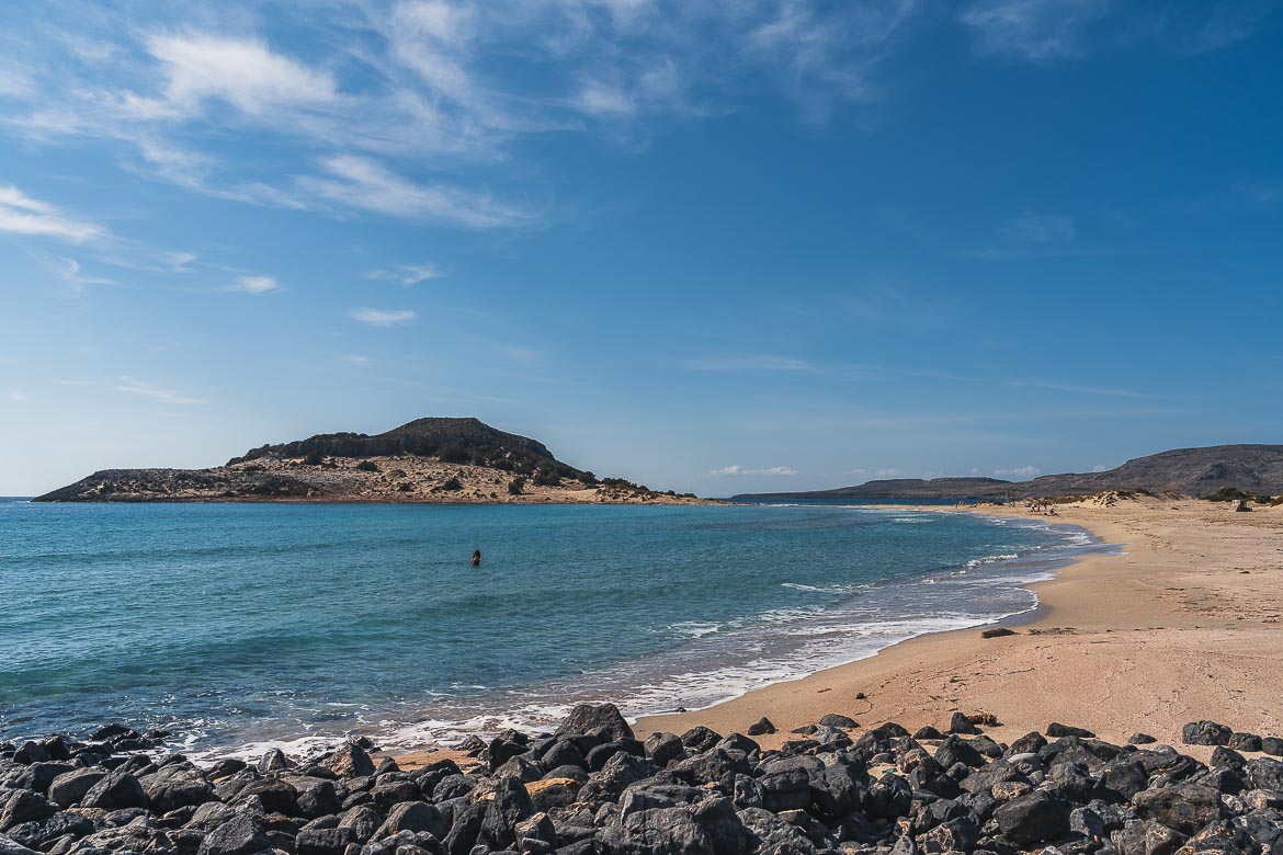 This is a panoramic shot of Mikros Simos Beach with its turquoise waters and golden sand. 