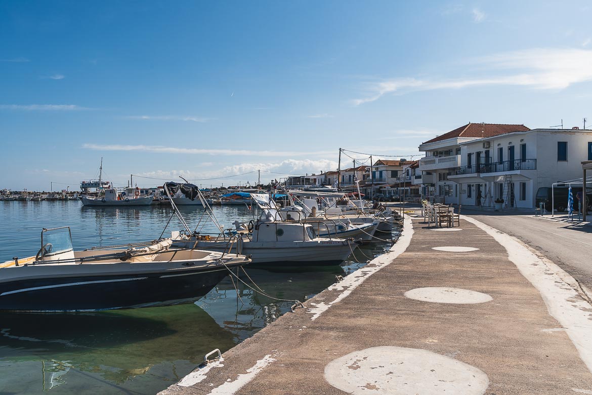 This is an image of the promenade in Elafonisos Town. There are many fishing boats anchored along the seafront. Walking along the promenade is one of the best things to do in Elafonisos.