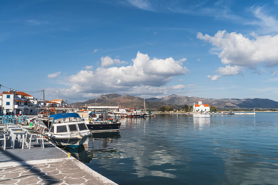 This is a panoramic shot of Elafonisos Town on a sunny day with the church of Agios Spiridonas in the background.