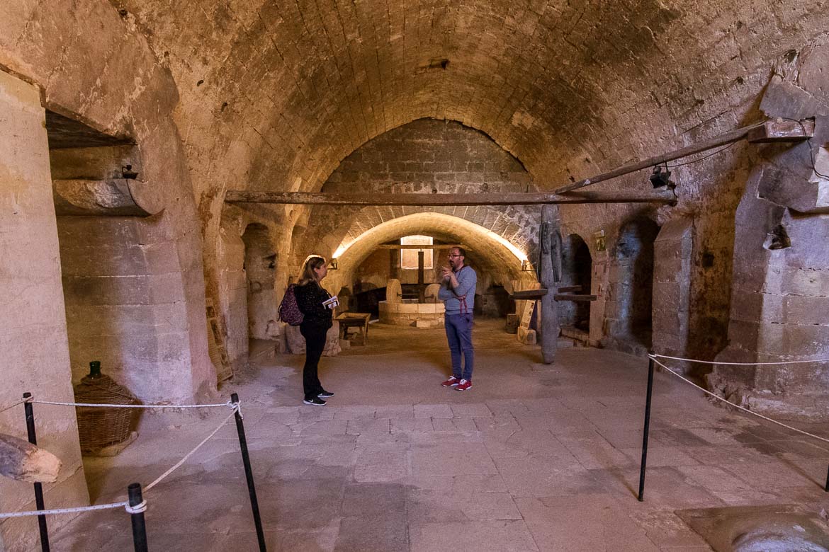 This is a photo of Pantaleo and Maria inside the semi undergound olive mill in Martignano. The olive mill is restored to perfection and very nicely lit. 