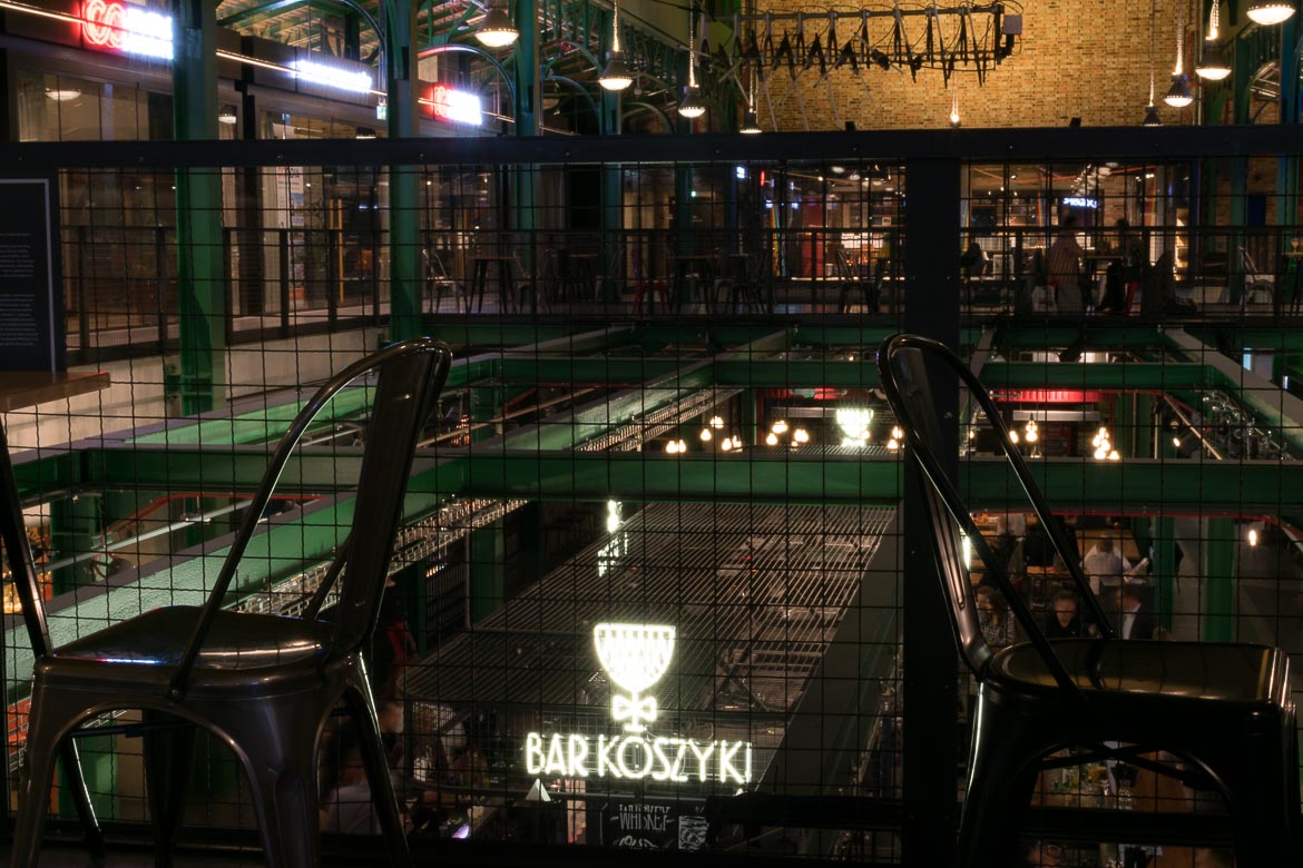 This is a panoramic view of the interior of Hala Koszyki.