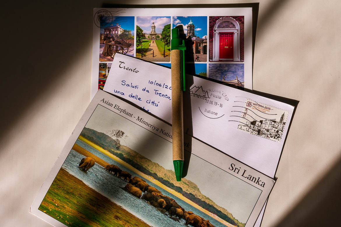 This is a close up of three postcards from our collection and a pen.