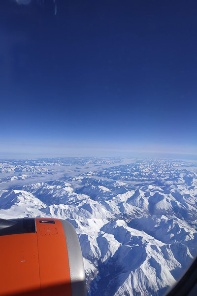 This image shows the view of snow-capped mountains from the aeroplane.