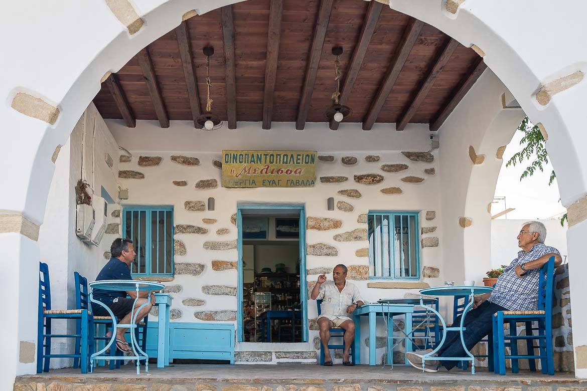Three locals are chatting at Melissa's patio. Everyone is sitting at their own tables.