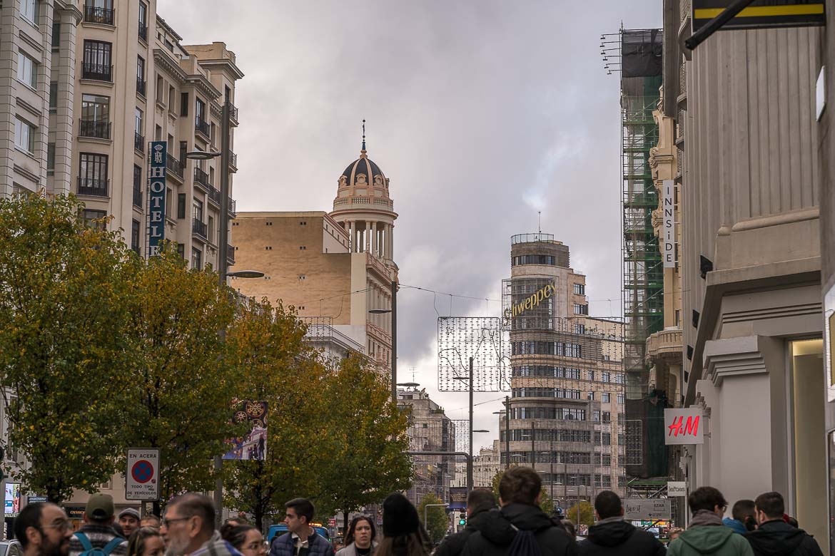 This image shows Gran Via with many people passing by.