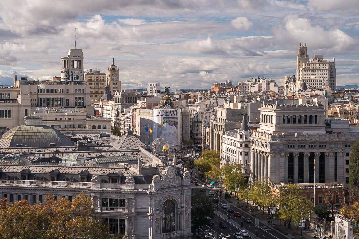 This image shows a panoramic view of Gran Via from the Palacio de Cibeles rooftop terrace.