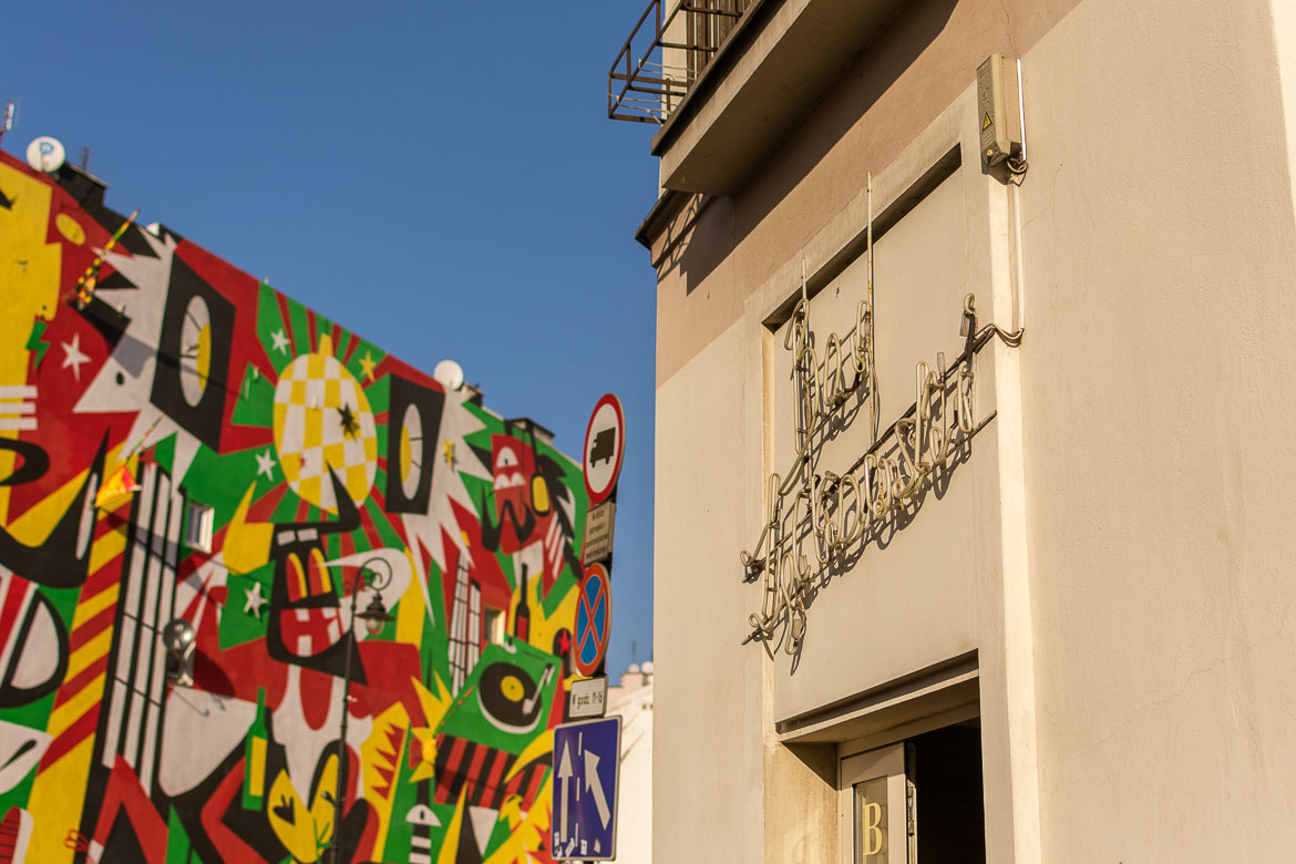 This image shows the facade of Bar Zabkowski. On the left, a graffiti with vivid colours.