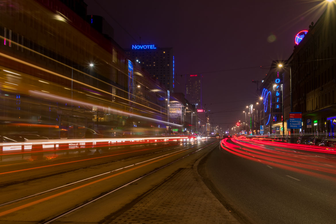This is a long exposure shot with night trails. In the background, the tall building that houses the Novotel.