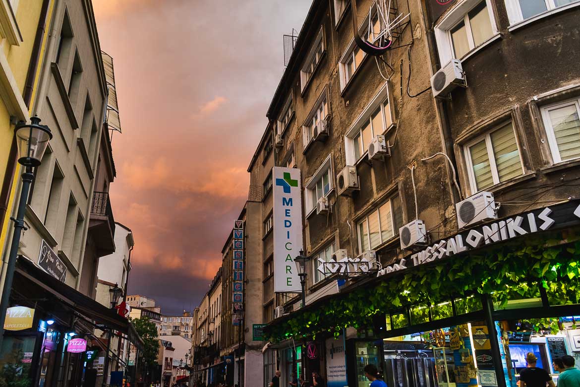 This is a photo of Bucharest Old Town under a dramatic sky before a storm. Strolling around the cobblestone streets of the old town is one of the top things to do in Bucharest, Romania.