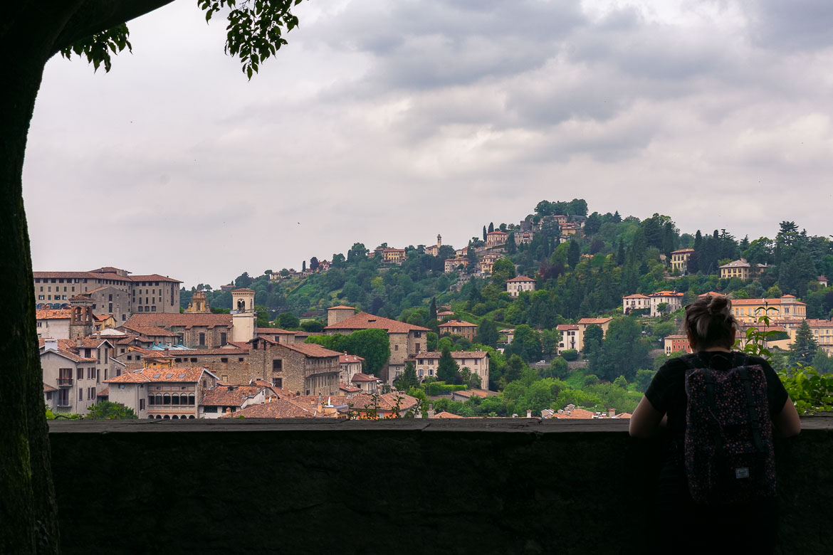 This image shows Maria with her back turned to the camera gazing at the view from Bergamo Castle.