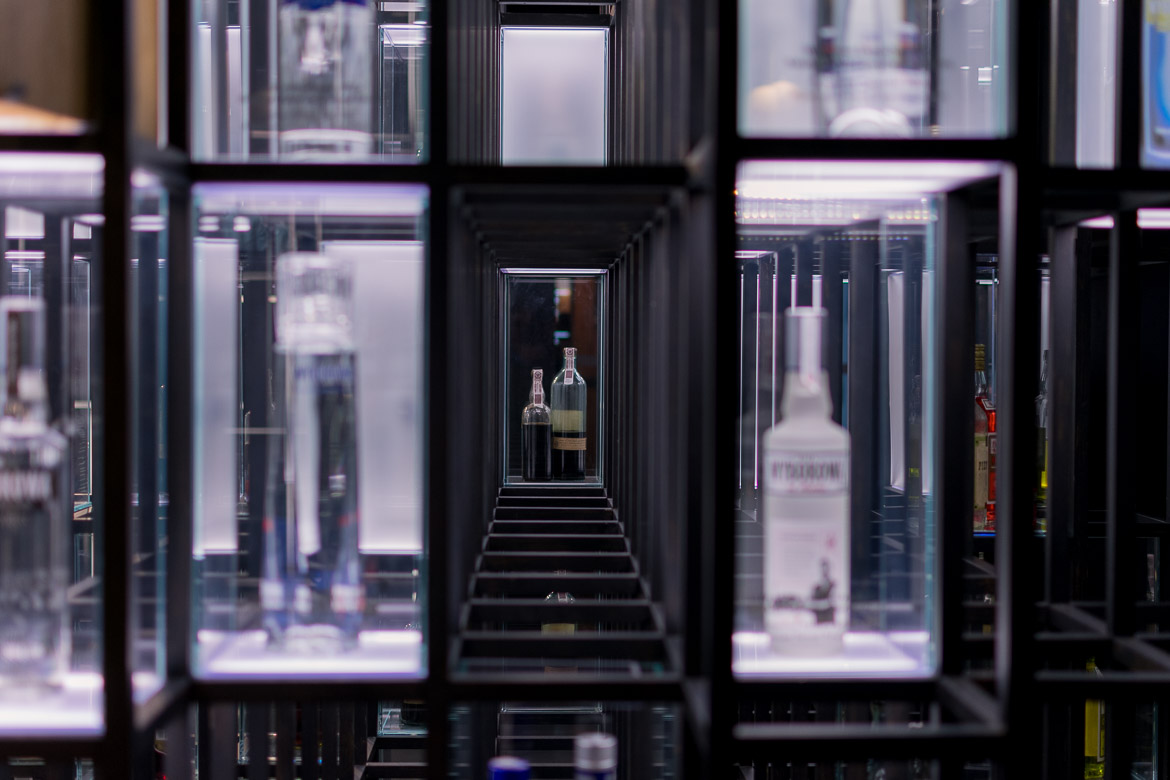 This image shows displays of vodka bottles inside the Polish Vodka Museum, one of the best places to visit in winter in Warsaw.