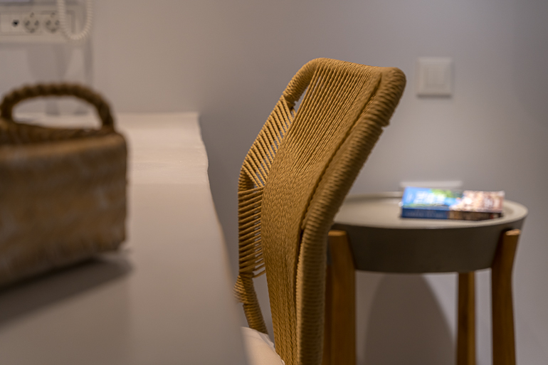 This image shows a chair in a room of Adonis Hotel in Paros.