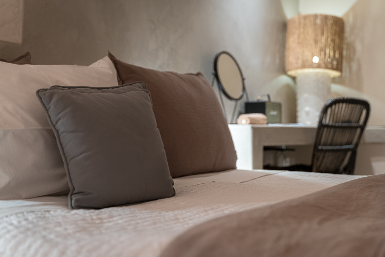 This image shows a room's bed at Verina Hotel in Sifnos.