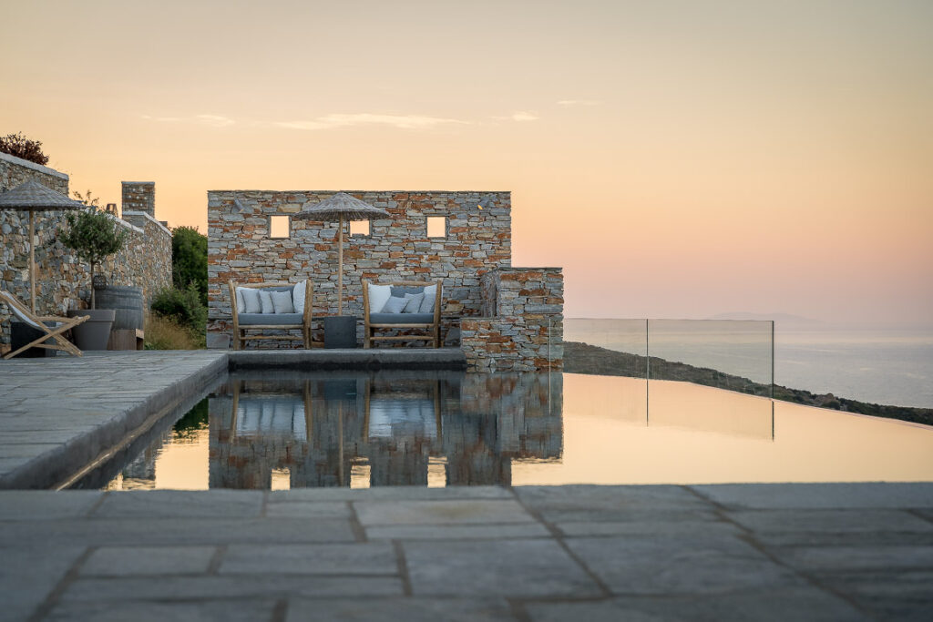 This image shows the swimming pool area of Verina Hotel in Sifnos at sunset.