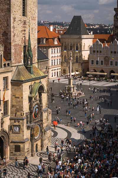 This image shows a panoramic view of people in front of the astronomical clock waiting for the Apostles Parade.