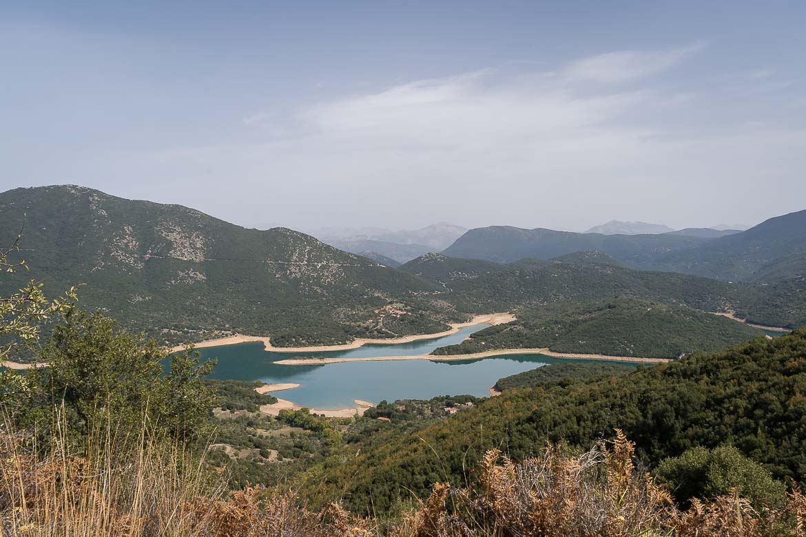 Panoramic view of the artificial Ladon Lake. The lake has fjords and green waters.