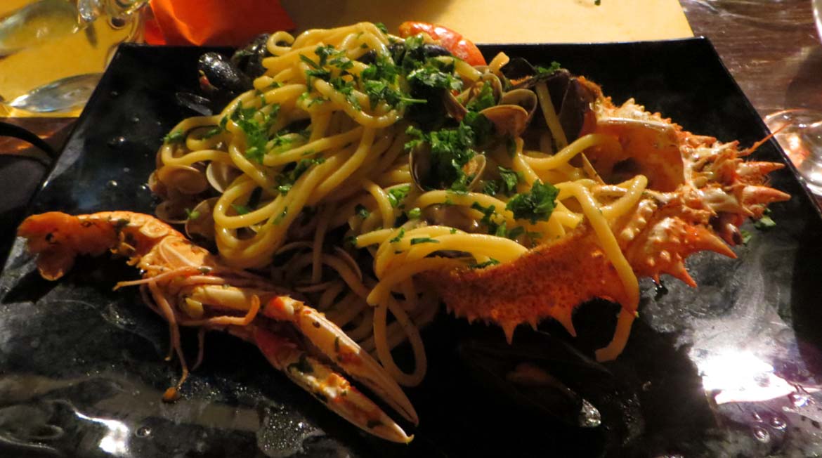 This photo shows a dish of seafood pasta in a restaurant in Venice, Italy. What to do in Venice: our complete guide to La Serenissima. Venice Italy. It's all trip to me.