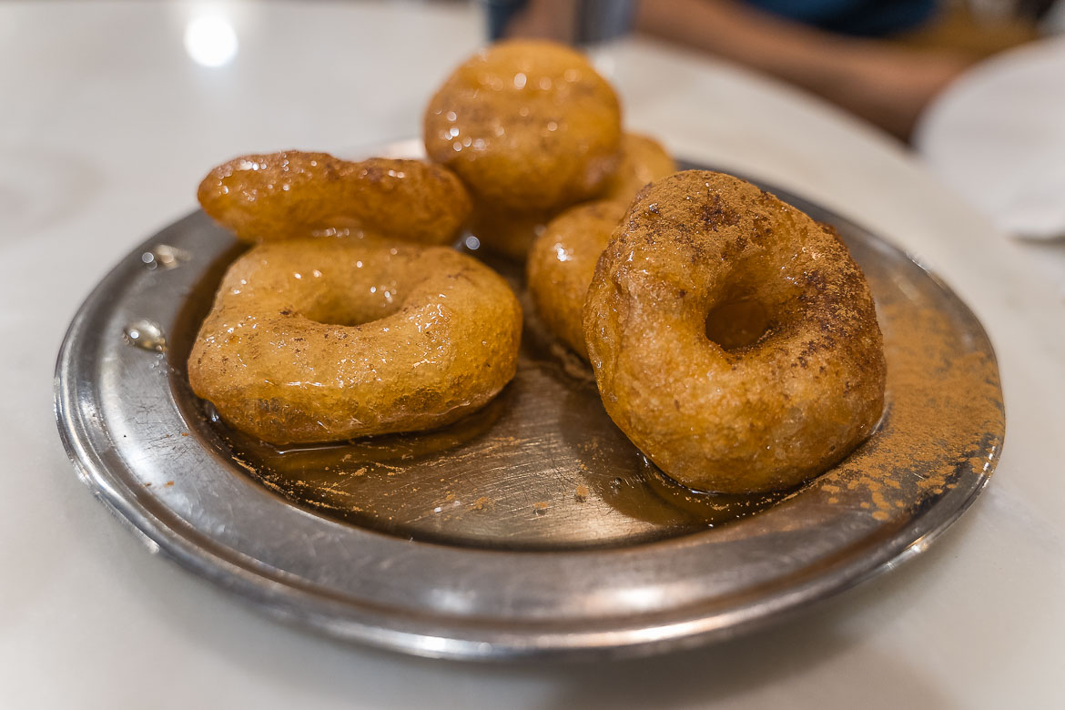 A portion of loukoumades with honey and cinnamon.