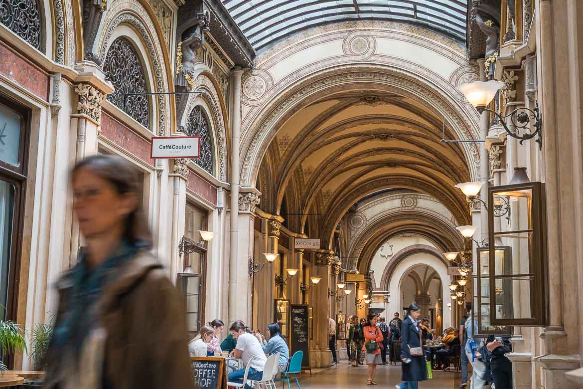 People take a stroll inside Ferstel Passage.