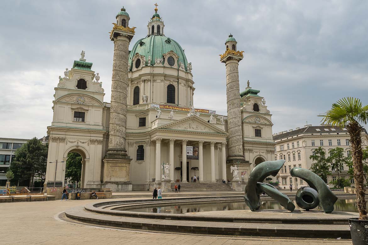 Karlskirche behind a pond with a modern sculpture.
