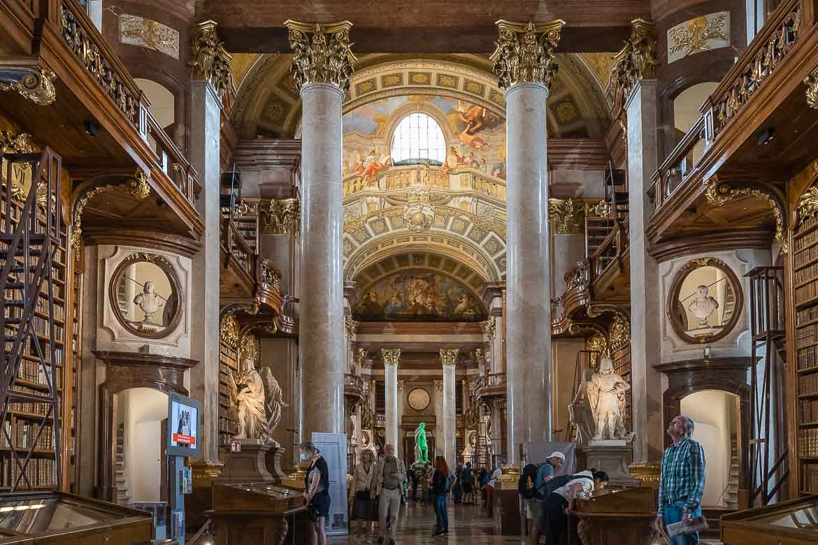 The National Library's interior with its wooden bookshelves and frescoes on the vaulted ceiling.