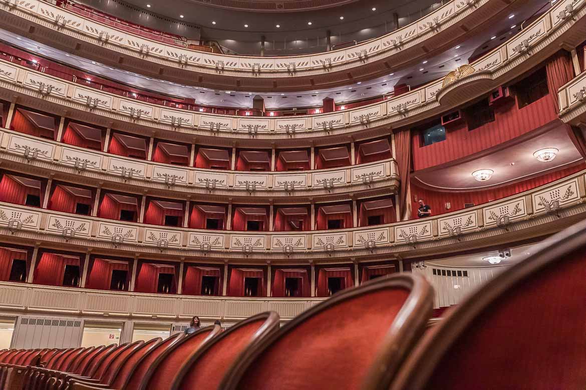 The Opera's opulent auditorium with red seats and balconies.