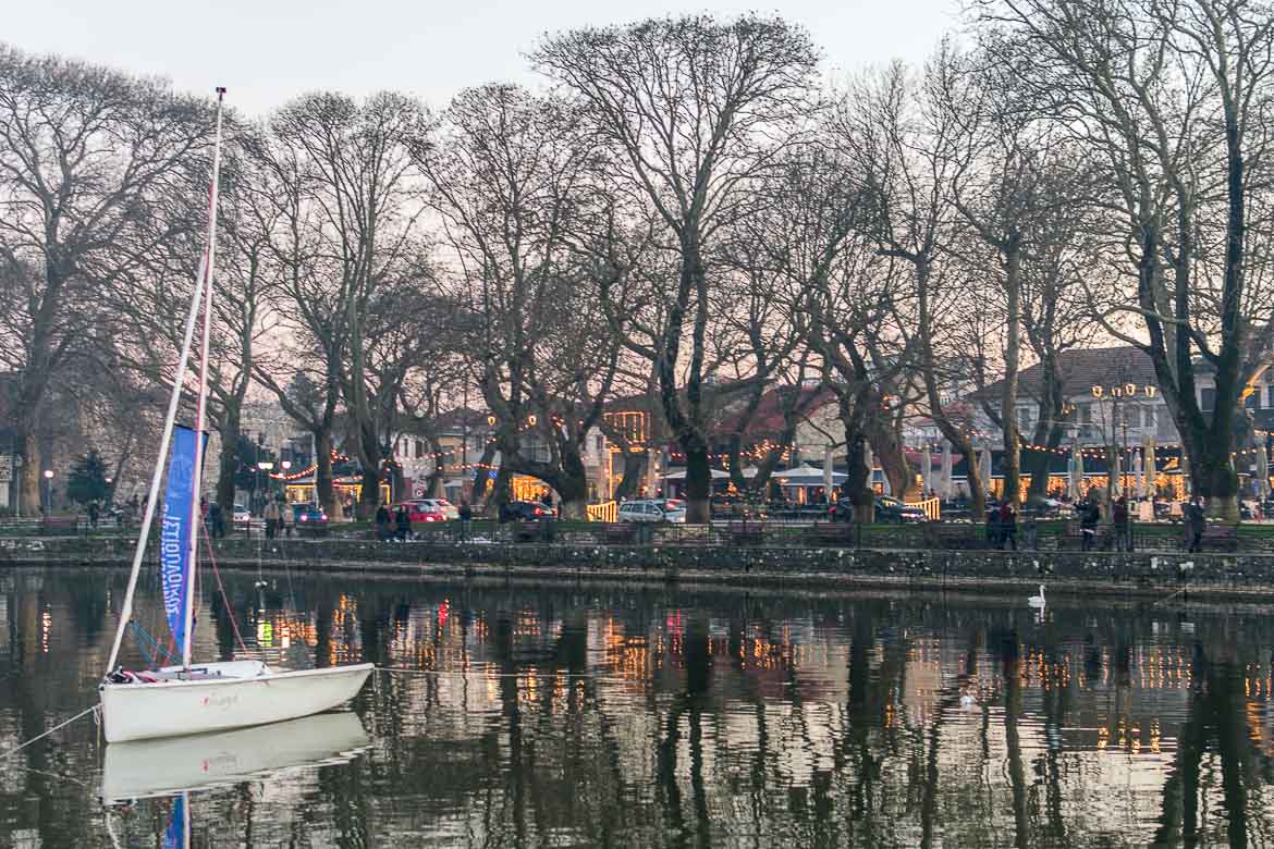 This photo shows the beautiful Ioannina lake. Lights reflect on the tranquil waters.