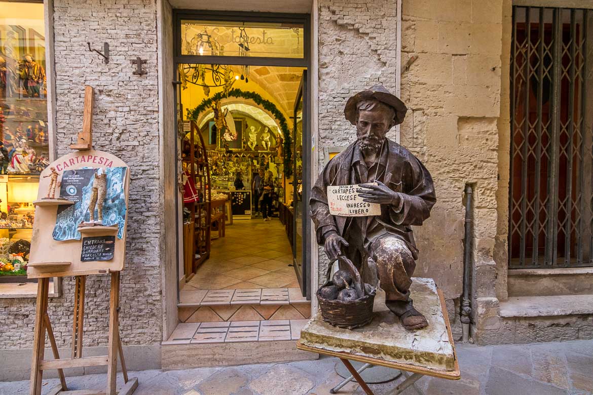This photo shows a man made of papier mache outside a workshop in the old town, Lecce Italy.