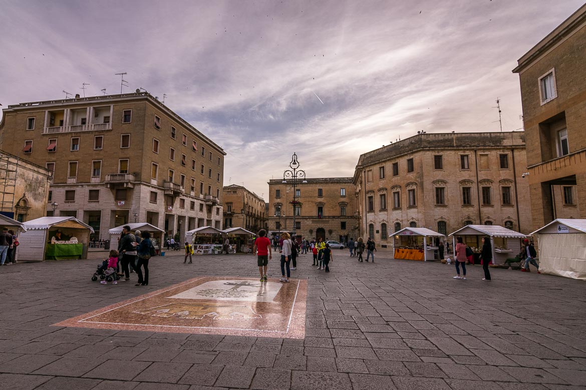 This photo shows Piazza Sant'Oronzo filled with people during the evening passeggiata. 
