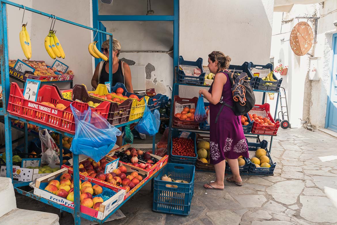 This image shows Maria shopping fruit and vegetables from a grocery in the old market of Naxos.