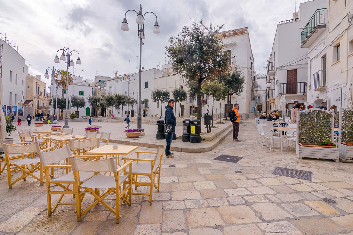 This photo shows a picturesque square in the Old Town. Wandering around the historic centre tops the list of what to do in Polignano a Mare.
