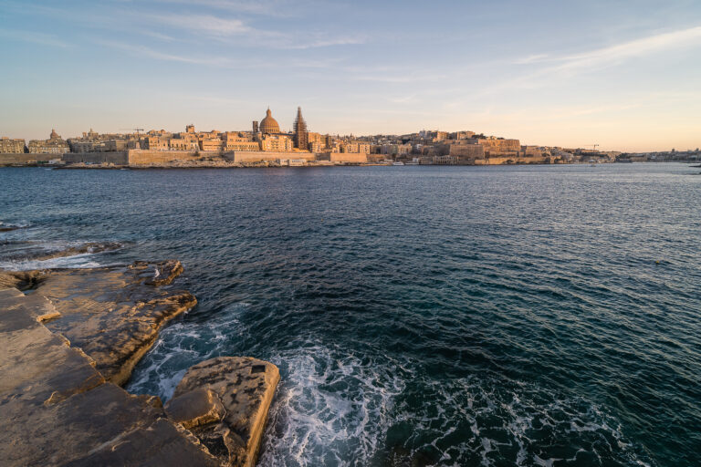 View of Valletta from Sliema promenade during sunset.