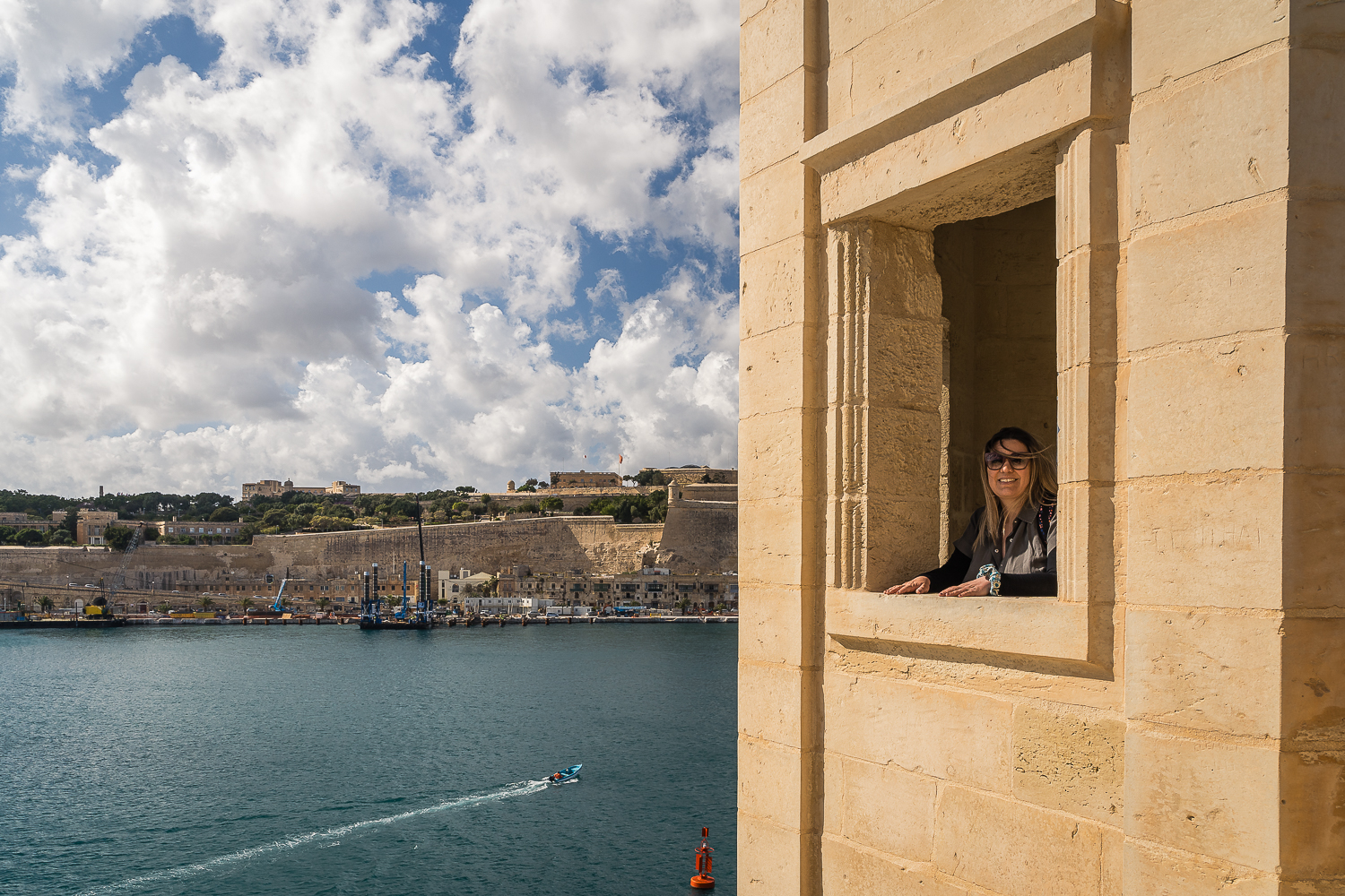 Maria is posing behind a window in Senglea's watchtower.