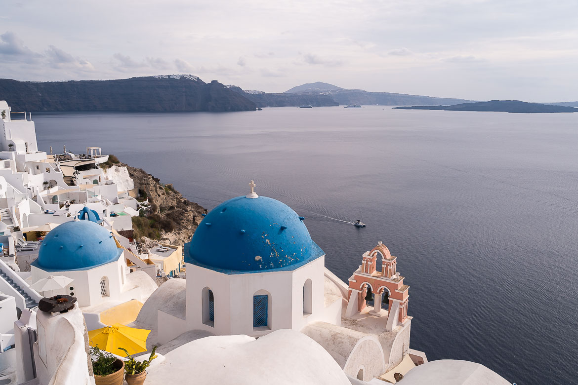 This image shows the iconic blue domes of Oia in Santorini