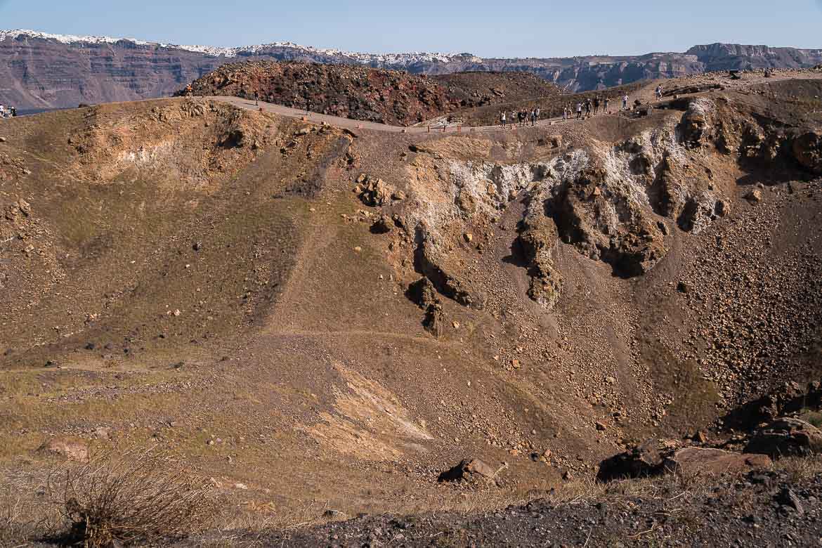 This image shows people walking along the rim of the impressive Georgios crater.