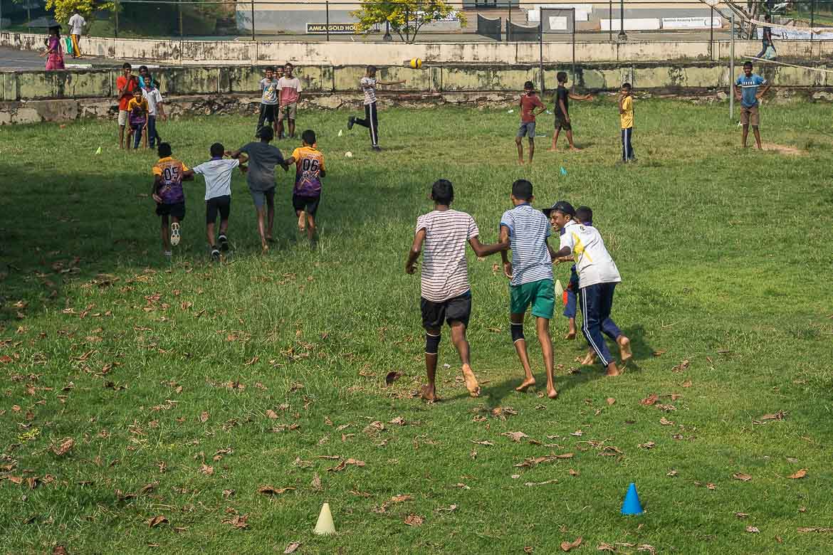 Children are playing games on the grass in Galle.