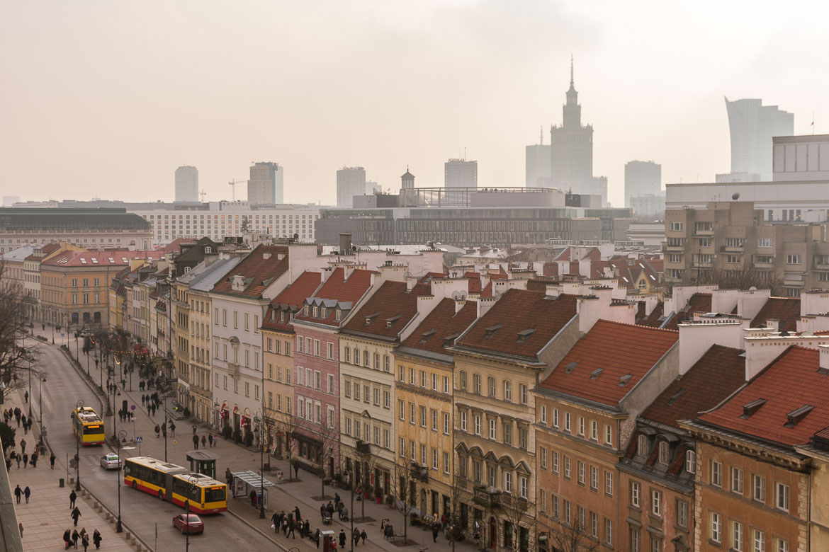 The view from the bell tower of St. Anne's church. In the foreground, the pastel-coloured buildings lining the Royal Route. In the background, Warsaw's dramatic Manhattan-like skyline.